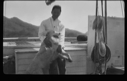 Image of Man on deck holding dog